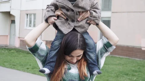 Boy child in a coat on mom Stock-Footage 129885271