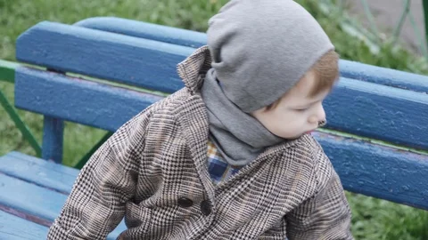 Boy child in a coat slides Stock Footage 129887867