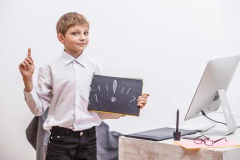 Boy child with a computer, in the office in a white shirt businessman Foto stock