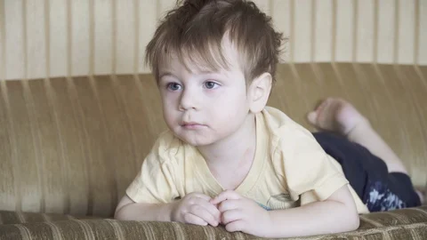 Boy child on the couch 스톡 동영상 126825790