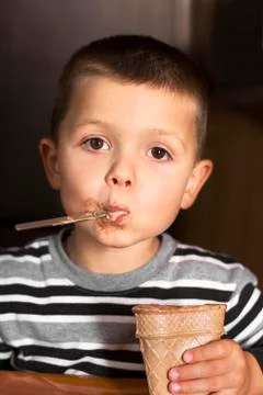 Boy. The child eats ice cream with a spoon. Child and sweet. Close-up Stock Photos