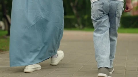 Boy child go on path in city park holdin... | Stock Video | Pond5