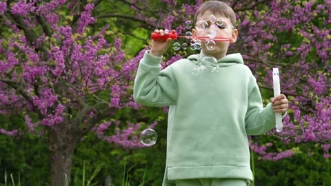 Boy child launches the soap bubbles. Stock Footage 154418249