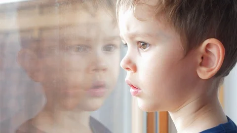 Boy, child looking through window glass Video stock 87141232