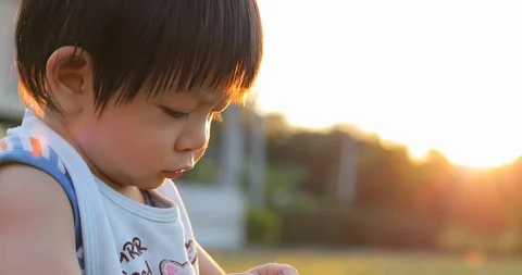 Boy child playing in playground with soft sunlight in the summer day background Stock Footage 86008964