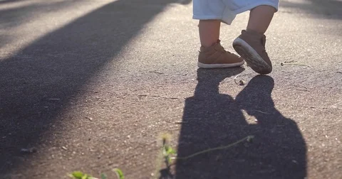 Boy child playing relaxation in the park, baby standing on street, close up shoe Stock Footage 85096089
