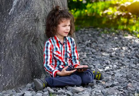 Boy Child playing with Tablet PC Outdoor with forest on background Computer G 스톡 사진