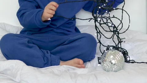 Boy child preschooler opens gift cardboard box with christmas toys Видео 220334855