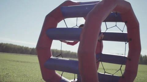Boy Child Walking and Playing in Rolling Cylinder Stock Footage 165593580