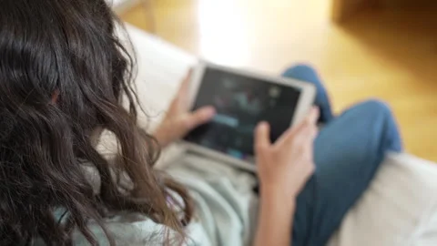 Boy choosing from a streaming video catalog with tablet Stock Footage 282915090