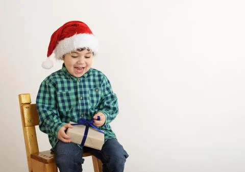 Boy with a christmas present Stock Photos