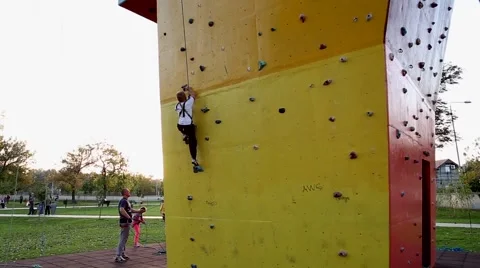 Boy clambering up the wall Stock Footage 42641752