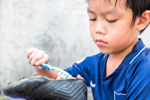 A boy is cleaning his stud after the match. He understand this is his respons Stock Photos