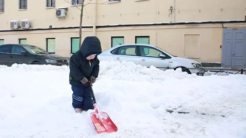 The boy cleans the snow Stock Footage 166753754