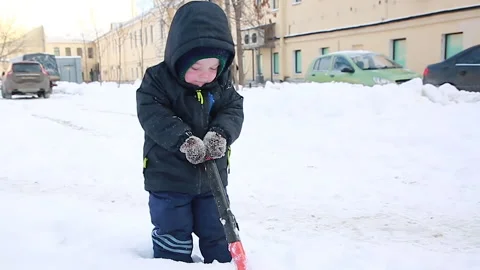 A boy cleans the snow in the yard Stock Footage 166962013