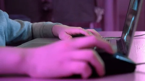 Boy clicking the mouse and typing on keyboard. Child playing games Stock Footage 123211305