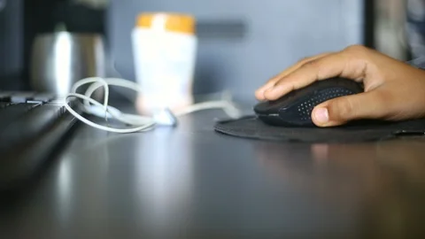 Boy Clicking on wireless mouse Stock Footage 129945256