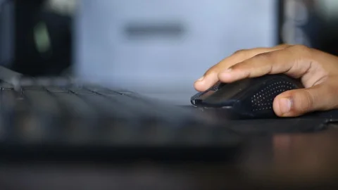 Boy Clicking on wireless mouse Stock Footage 129947088