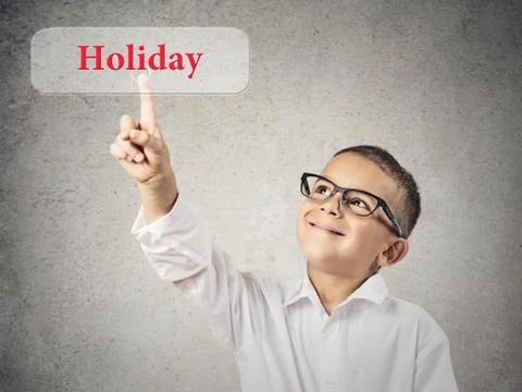 Boy clicks on Holiday button Stock Photos