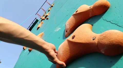 Boy climbing up the artificial wall Stock Footage 42639176