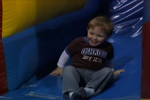 Boy Climbing Off of Little Slide Stock Footage 10704767