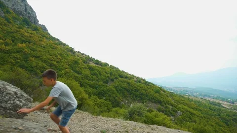 Boy Climbing Mountain Path In Summer Stock Footage 115126839