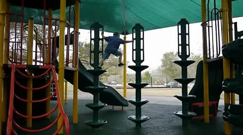 Boy climbing on a playground Stock Footage 10737398
