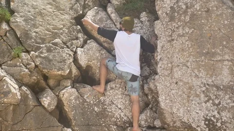 Boy Climbing Rocks Summer Vibes Slowmotion 4k Stock Footage 77249591