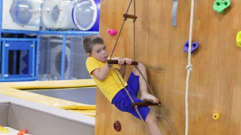 Boy climbing a rope ladder. Stock Footage 264044668