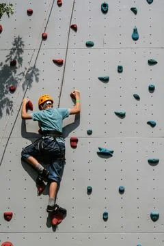 Boy on climbing wall Stock Photos