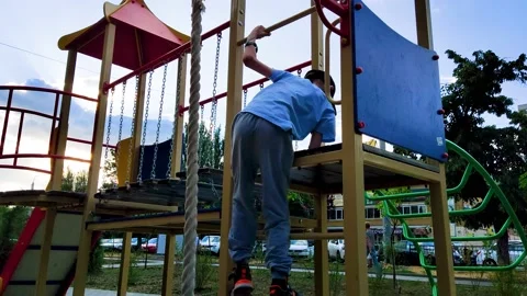 The boy climbs the children's slide Stock Footage 199984285