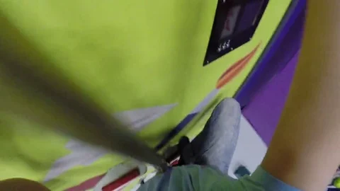 Boy climbs down in attraction in Climbing Center, FPV, man stands with camera Stockbeeldmateriaal 69163540