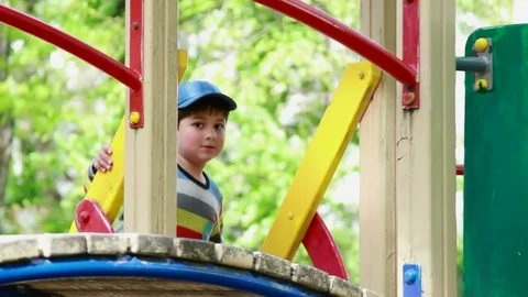 The boy climbs the ladder on the playground Video stock 76428542