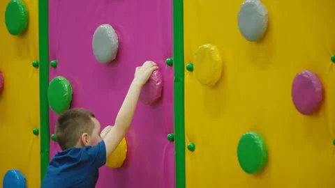 The boy climbs the wall Stock-Footage 107050693