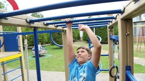 The boy clings to a horizontal bar Stock Footage 52433297