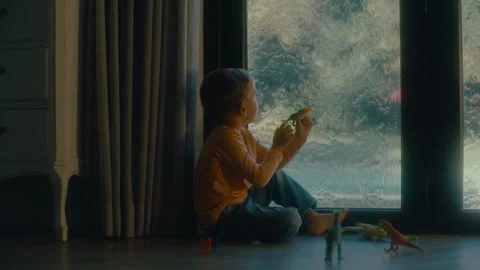 Boy close to a window during rain Stock Footage 279073449
