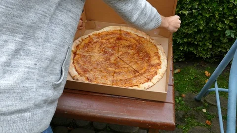 Boy closes pizza box 動画素材 118526379