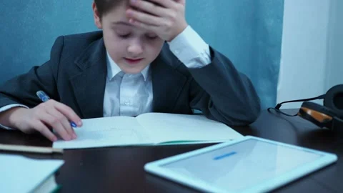 The boy clutches his head to the jacket and can't solve the problem. shot in out Stock Footage 144179978