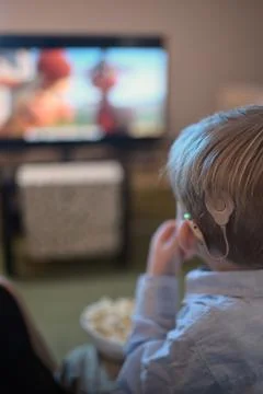 A Boy With Cochlear Implants watching Television Stock Photos