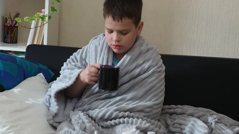 A boy with a cold is at home, being treated. medicines, throat and nose spray Stock Footage 164471776
