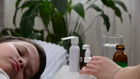 A boy with a cold is at home, treated. medicines, medicine, throat nose spray 库存影片 148769982