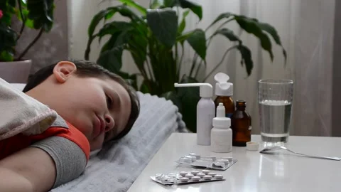 A boy with a cold is at home, treated. medicines, medicine, throat nose spray Stock Footage 148771099