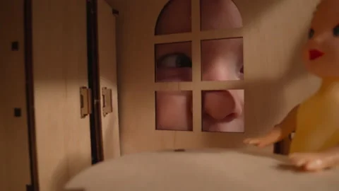 Boy with cold stares through window of miniature dollhouse Stock-Footage 210462008