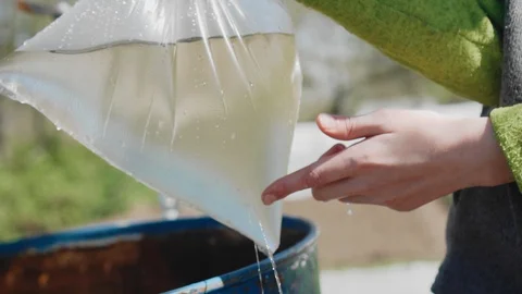The boy collected the water in a leaky plastic bag Stock Footage 130049800