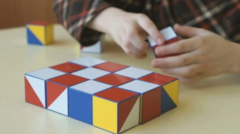 Boy collecting a pattern using colored cubes Video stock 64084014