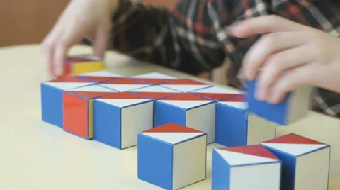 Boy collecting a pattern using colored cubes Video stock 64223463