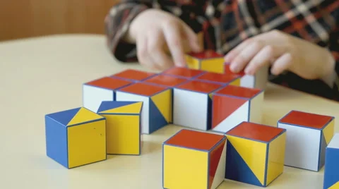 Boy collecting a pattern using colored cubes Video stock 64540149