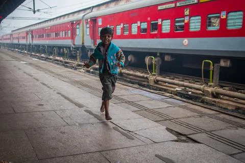 Boy collecting plastic garbage in at the train station for income generation. Stock Photos