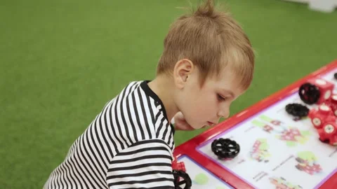 A boy collects a magnetic constructor Stock-Footage 203781154