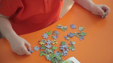 Boy collects a puzzle Stock Footage 62488677